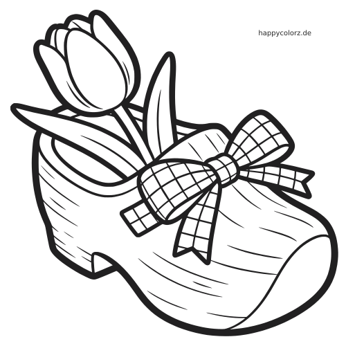 Eine einfache schwarz-weiße Tulpe steckt in einem holländischen Holzschuh und ist mit einer großen karierten Schleife verziert.